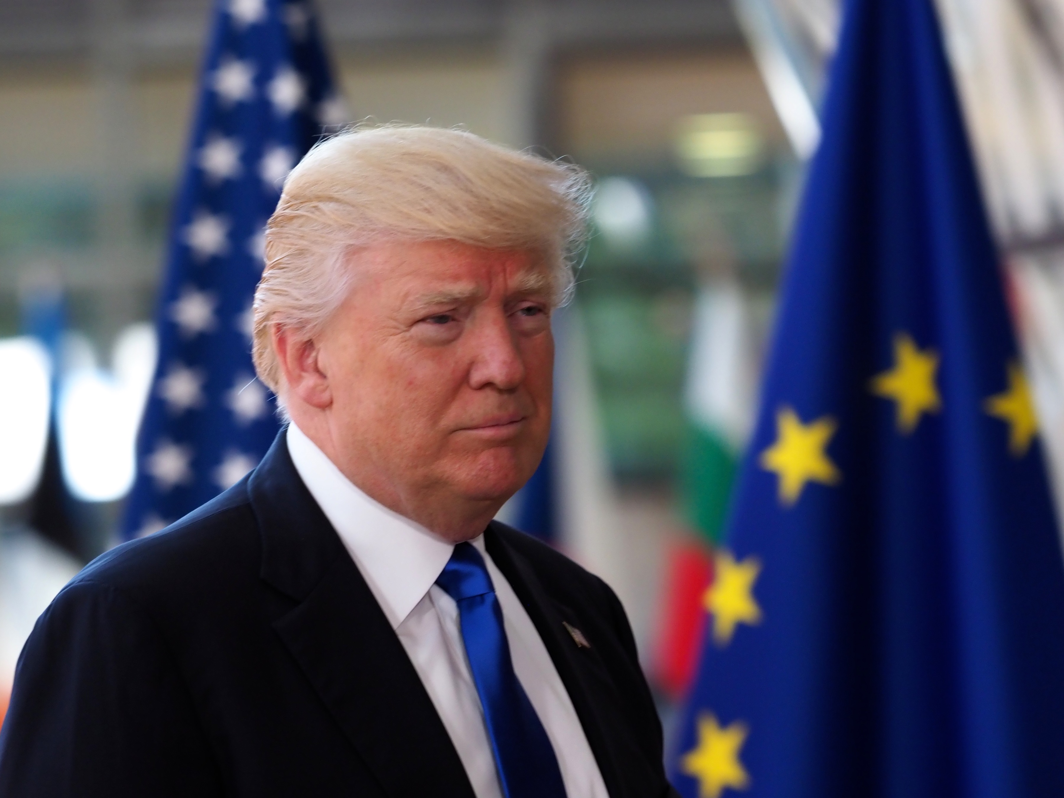 US President Donlad Trump in Brussels with US and EU flags.